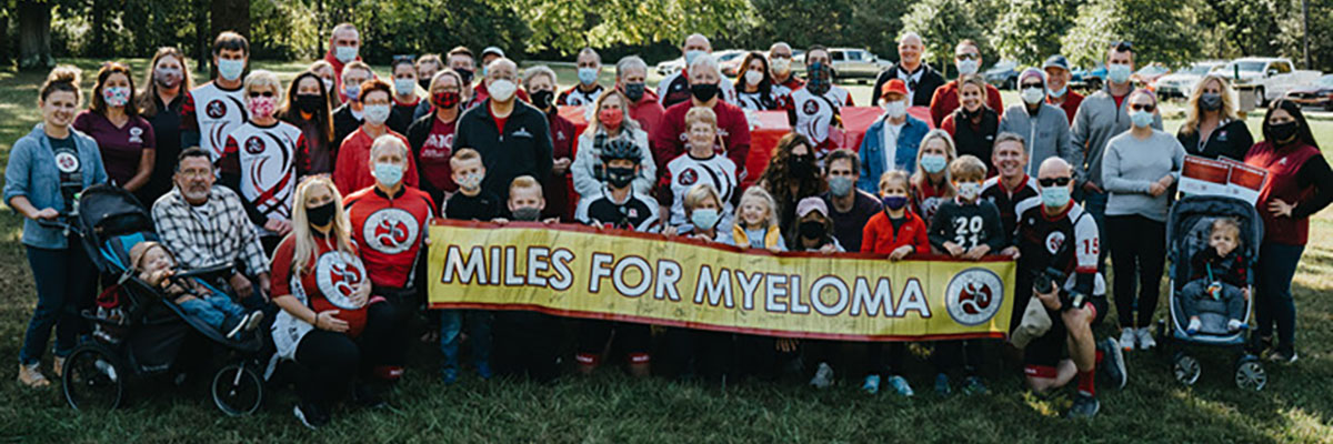 Group photo of 2021 ride participants and volunteers holding a “Miles for Myeloma” banner