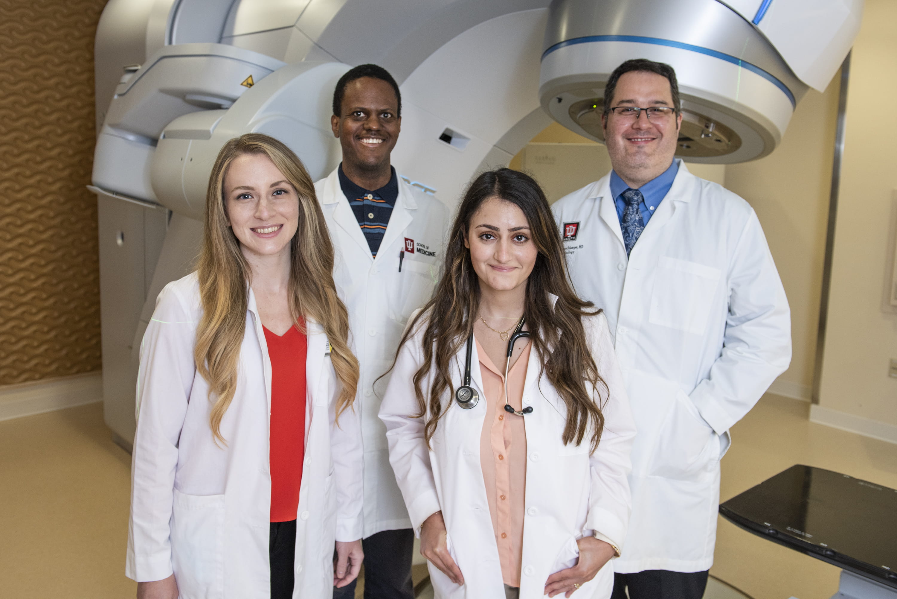 Four medical residents in the Radiation Oncology program with faculty member